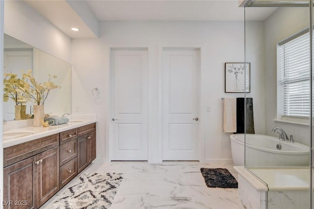 350 Gandara St, Las Vegas, NV 89138 - full bath featuring a freestanding bath, double vanity, marble finish flooring, recessed lighting, and baseboards