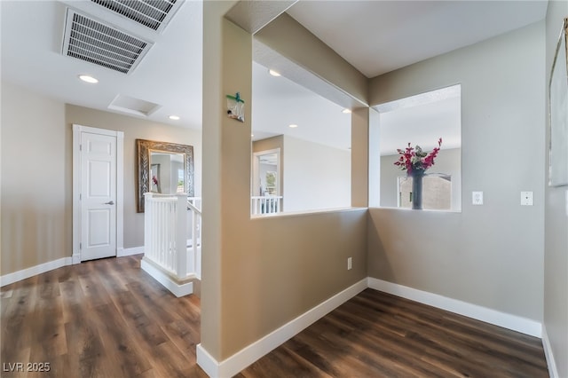 hallway featuring dark wood-style floors, baseboards, attic access, and recessed lighting