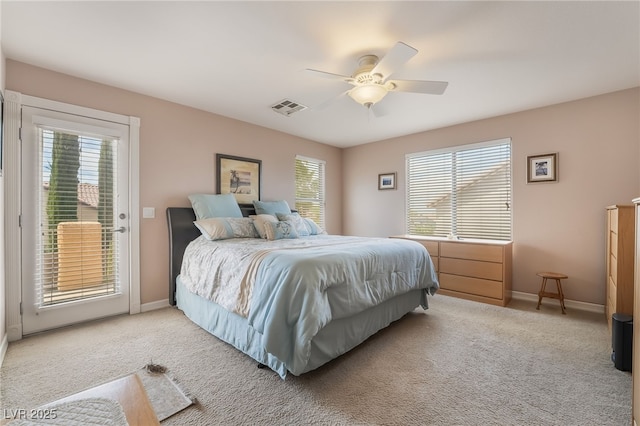 bedroom with access to exterior, multiple windows, baseboards, and carpet flooring