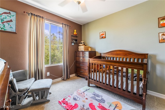 carpeted bedroom with baseboards and a ceiling fan