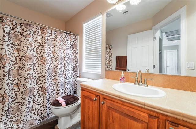 bathroom with toilet and vanity