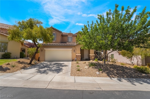 view of front of home with stucco siding, driveway, a tiled roof, and an attached garage