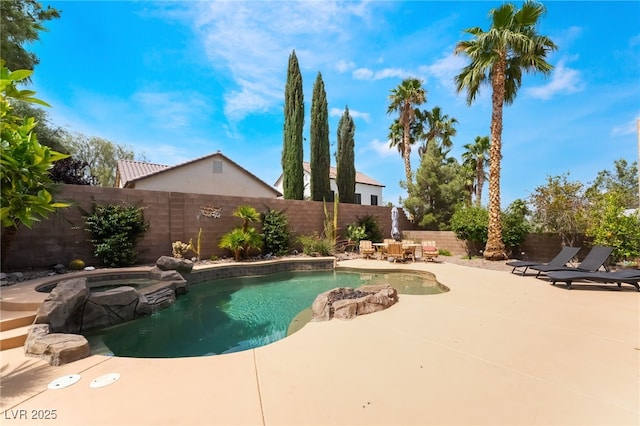view of swimming pool featuring a fenced backyard, a patio, and a pool with connected hot tub