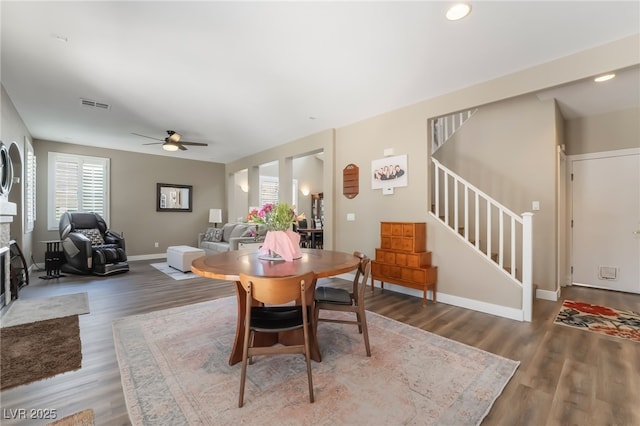 dining area featuring stairway, wood finished floors, ceiling fan, baseboards, and recessed lighting