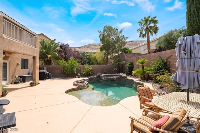 view of swimming pool with a fenced backyard, a patio, and a pool with connected hot tub