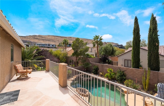balcony with a residential view and view of pool