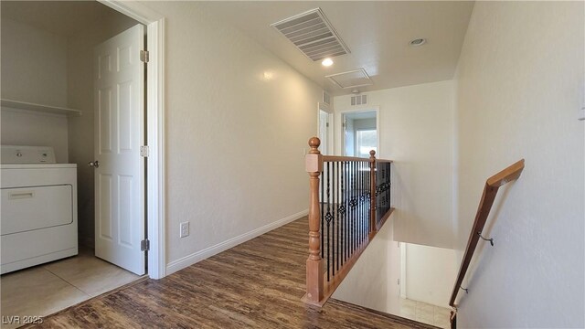 386 Botanic Gardens Dr, Las Vegas, NV 89148 - corridor featuring washer / clothes dryer, an upstairs landing, attic access, wood finished floors, and baseboards