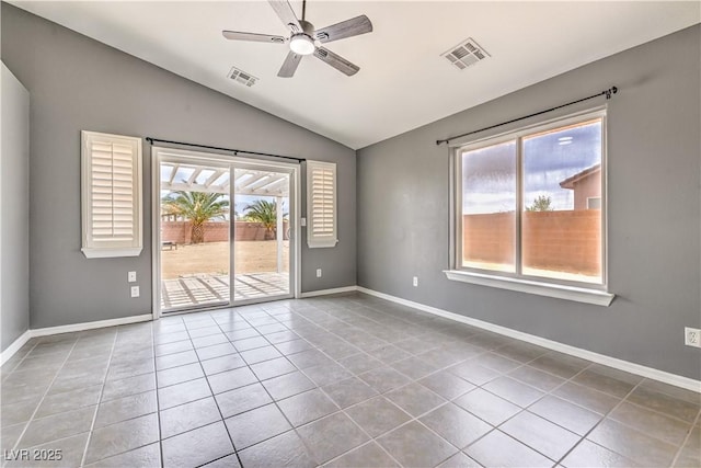 tiled spare room with vaulted ceiling, a ceiling fan, and baseboards