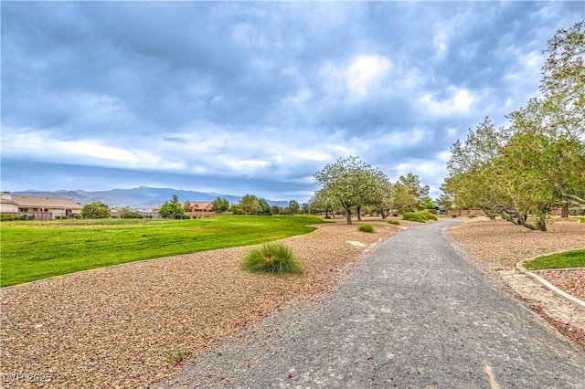 surrounding community featuring a mountain view and a yard
