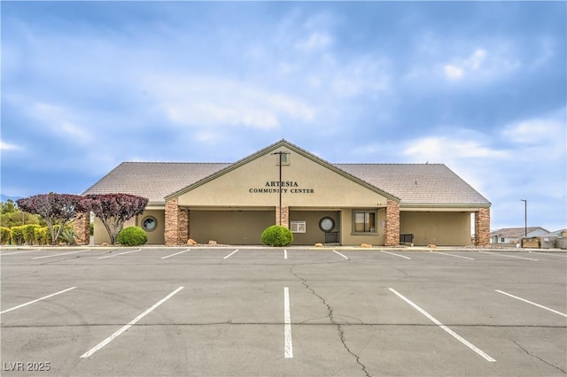 view of building exterior featuring uncovered parking