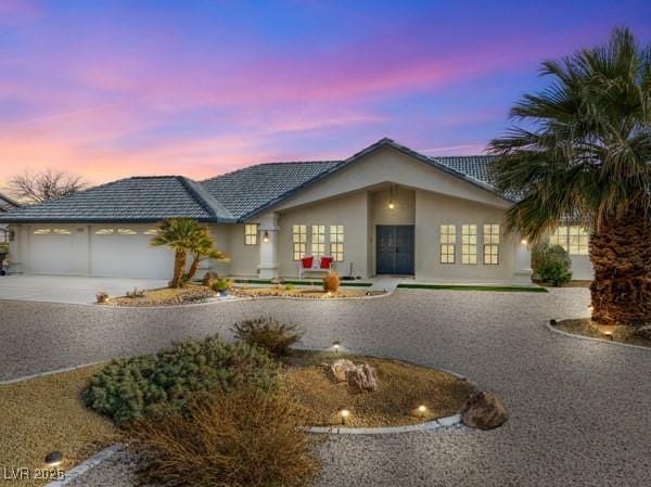 1251 Cavalry St, Pahrump, NV 89048 - view of front of property with french doors, driveway, a garage, and stucco siding
