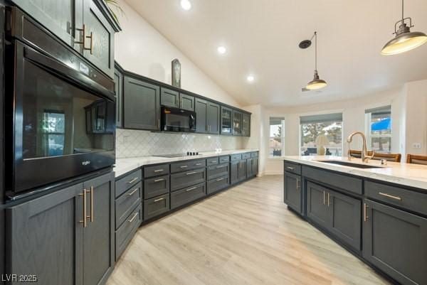 1251 Cavalry St, Pahrump, NV 89048 - kitchen featuring black appliances, a sink, light countertops, recessed lighting, and hanging light fixtures