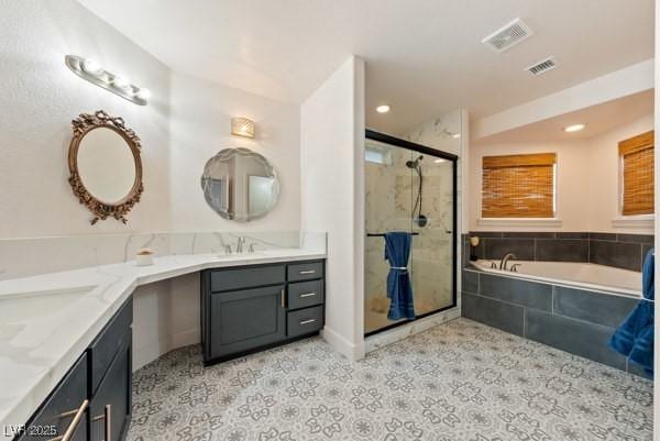 1251 Cavalry St, Pahrump, NV 89048 - full bathroom featuring double vanity, a shower stall, a bath, recessed lighting, and baseboards