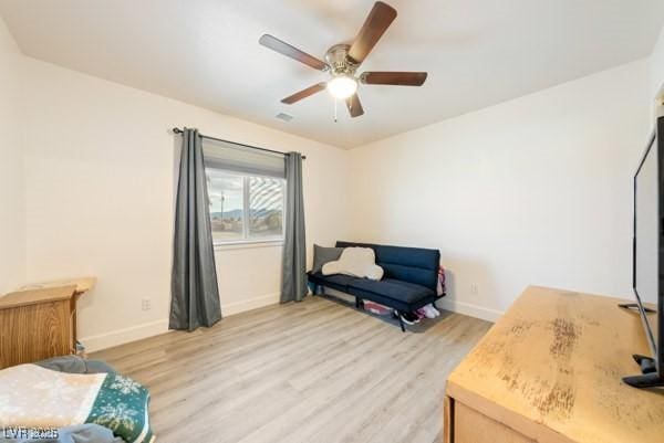 1251 Cavalry St, Pahrump, NV 89048 - sitting room with light wood-style floors, ceiling fan, and baseboards