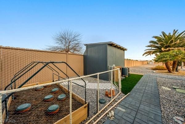 1251 Cavalry St, Pahrump, NV 89048 - view of yard featuring a garden, central air condition unit, and fence
