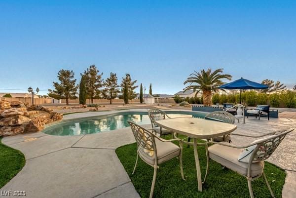 1251 Cavalry St, Pahrump, NV 89048 - view of pool with a patio area, fence, and outdoor dining space