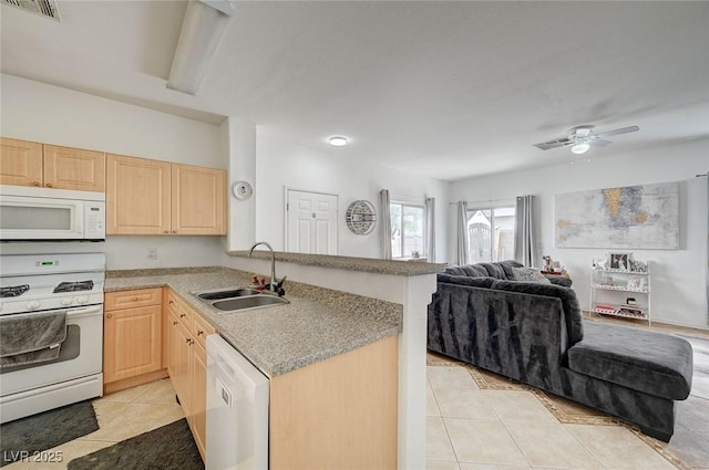 kitchen with white appliances, light brown cabinets, a sink, and light tile patterned floors