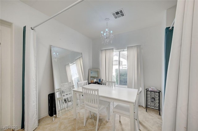 dining space featuring a chandelier and light tile patterned flooring