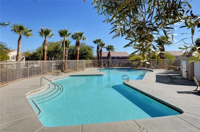 community pool with fence and a patio