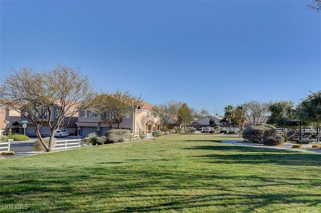 view of home's community featuring a yard and a residential view