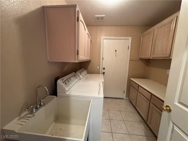 3136 Jane Austin Ave, North Las Vegas, NV 89031 - laundry room with cabinet space, washing machine and clothes dryer, and light tile patterned floors
