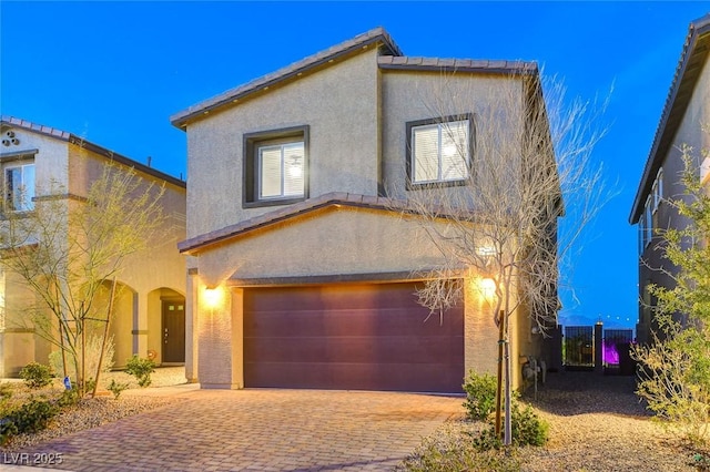 5236 Sunstone Mesa Dr, Las Vegas, NV 89166 - view of front of property with stucco siding, an attached garage, and decorative driveway
