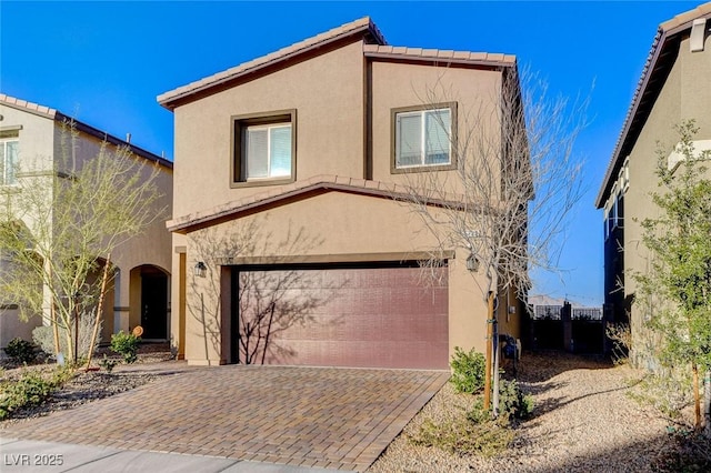 5236 Sunstone Mesa Dr, Las Vegas, NV 89166 - view of front of home with stucco siding, a tiled roof, an attached garage, and decorative driveway