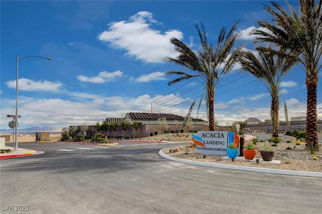 5236 Sunstone Mesa Dr, Las Vegas, NV 89166 - view of asphalt road featuring curbs and street lights