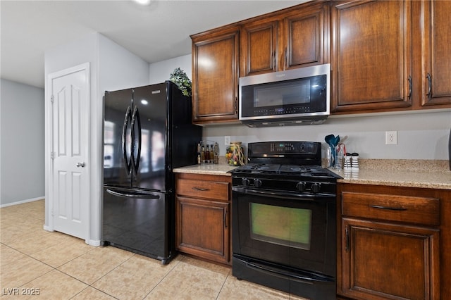 10440 Bay Ginger Ln, Las Vegas, NV 89135 - kitchen with black appliances, light tile patterned flooring, and baseboards