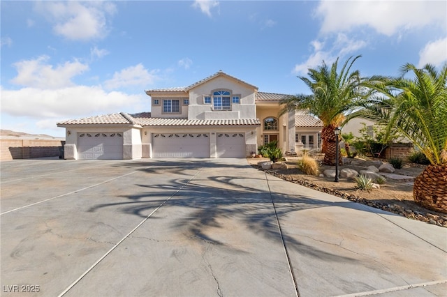 6999 Stone Meadows Ave, Las Vegas, NV 89142 - mediterranean / spanish home with stucco siding, driveway, a tile roof, and an attached garage