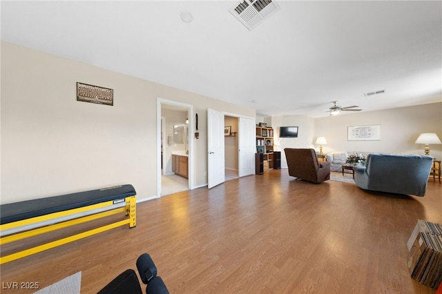 6999 Stone Meadows Ave, Las Vegas, NV 89142 - living room featuring a ceiling fan, wood finished floors, and baseboards