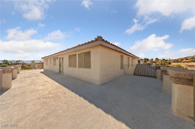 6999 Stone Meadows Ave, Las Vegas, NV 89142 - view of home's exterior featuring stucco siding, a patio area, and a tile roof