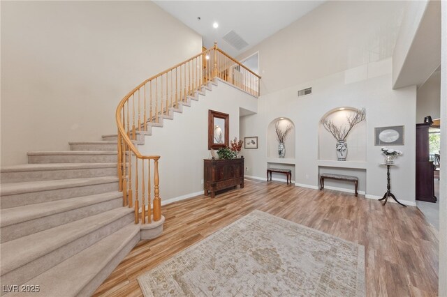 6999 Stone Meadows Ave, Las Vegas, NV 89142 - staircase featuring wood finished floors, a high ceiling, baseboards, and recessed lighting