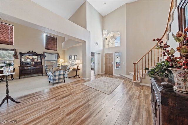 6999 Stone Meadows Ave, Las Vegas, NV 89142 - entryway featuring stairway, light wood-style flooring, a high ceiling, and baseboards