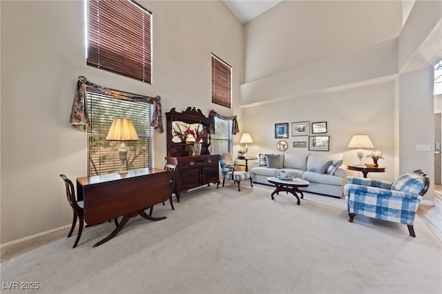 6999 Stone Meadows Ave, Las Vegas, NV 89142 - living area with a towering ceiling, carpet, healthy amount of natural light, and baseboards