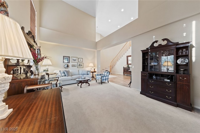 6999 Stone Meadows Ave, Las Vegas, NV 89142 - living room featuring stairway, carpet, high vaulted ceiling, baseboards, and recessed lighting