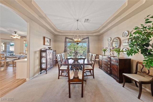 6999 Stone Meadows Ave, Las Vegas, NV 89142 - dining space featuring a chandelier, a raised ceiling, light carpet, and baseboards