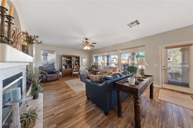 6999 Stone Meadows Ave, Las Vegas, NV 89142 - living area featuring wood finished floors, ceiling fan, and a tile fireplace
