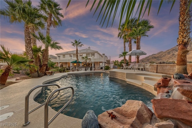 6999 Stone Meadows Ave, Las Vegas, NV 89142 - pool at dusk with a patio area and a mountain view