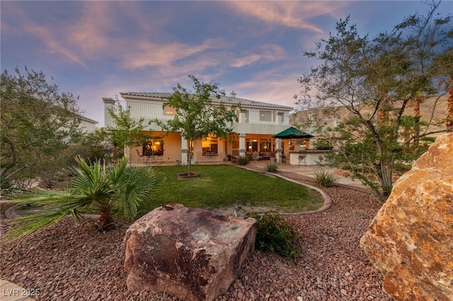 6999 Stone Meadows Ave, Las Vegas, NV 89142 - rear view of property with a yard, a patio, and stucco siding