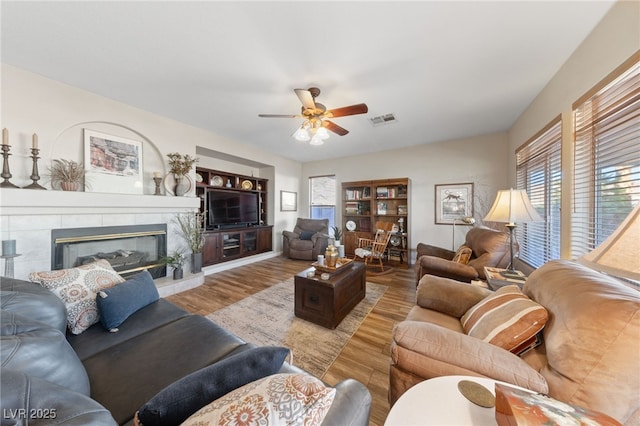 6999 Stone Meadows Ave, Las Vegas, NV 89142 - living area featuring ceiling fan, wood finished floors, plenty of natural light, and a tile fireplace