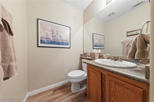 6999 Stone Meadows Ave, Las Vegas, NV 89142 - bathroom with vanity, wood finished floors, toilet, and baseboards