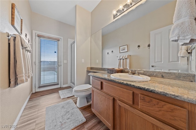 6999 Stone Meadows Ave, Las Vegas, NV 89142 - full bathroom featuring toilet, vanity, a shower stall, baseboards, and wood finished floors