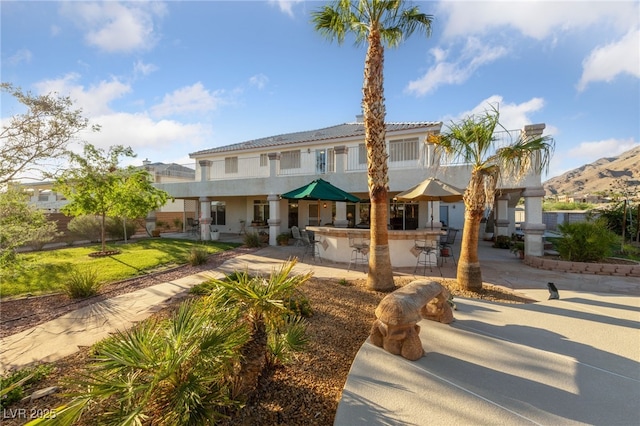 6999 Stone Meadows Ave, Las Vegas, NV 89142 - view of front of home featuring stucco siding, a patio area, and a mountain view