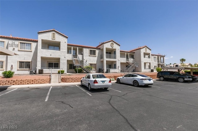 3318 N Decatur Blvd Unit 2110, Las Vegas, NV 89130 - view of property with uncovered parking, stairway, and central AC