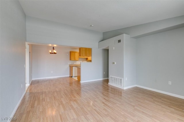 3318 N Decatur Blvd Unit 2110, Las Vegas, NV 89130 - unfurnished living room featuring a chandelier, light wood-style flooring, baseboards, and lofted ceiling