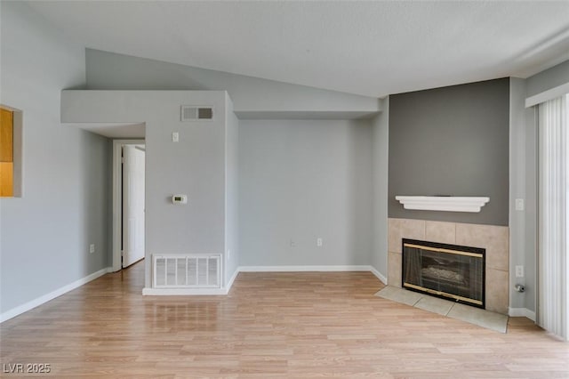 3318 N Decatur Blvd Unit 2110, Las Vegas, NV 89130 - unfurnished living room with wood finished floors, a fireplace, vaulted ceiling, and baseboards