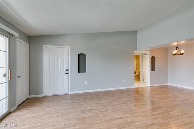 3318 N Decatur Blvd Unit 2110, Las Vegas, NV 89130 - unfurnished living room featuring a chandelier, light wood-style flooring, and baseboards