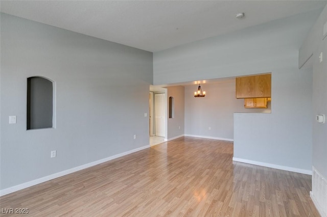 3318 N Decatur Blvd Unit 2110, Las Vegas, NV 89130 - unfurnished room featuring a chandelier, light wood-type flooring, and baseboards