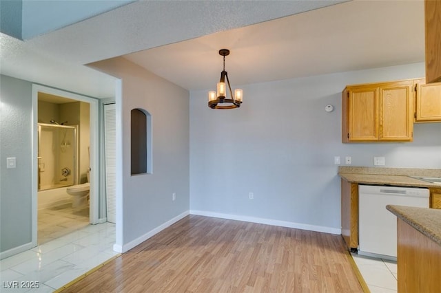 3318 N Decatur Blvd Unit 2110, Las Vegas, NV 89130 - unfurnished dining area featuring baseboards, a chandelier, and light wood-style floors